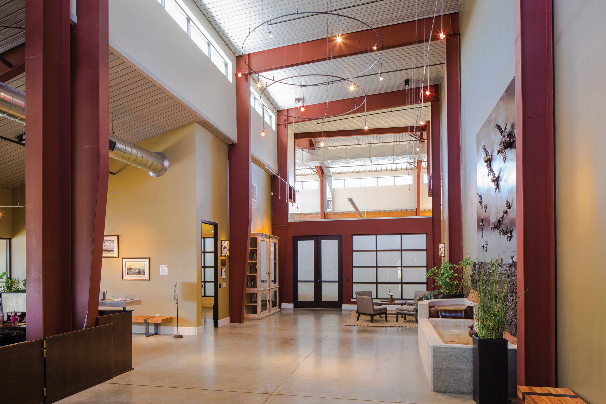 Lundberg Family Farms open lobby with exposed red steel beams and modern seating areas