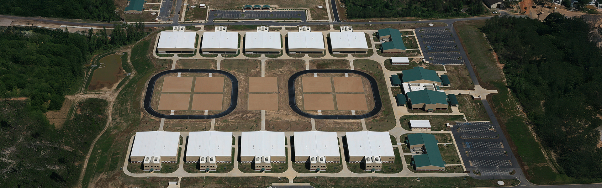 Aerial view of a large military training facility with multiple metal buildings