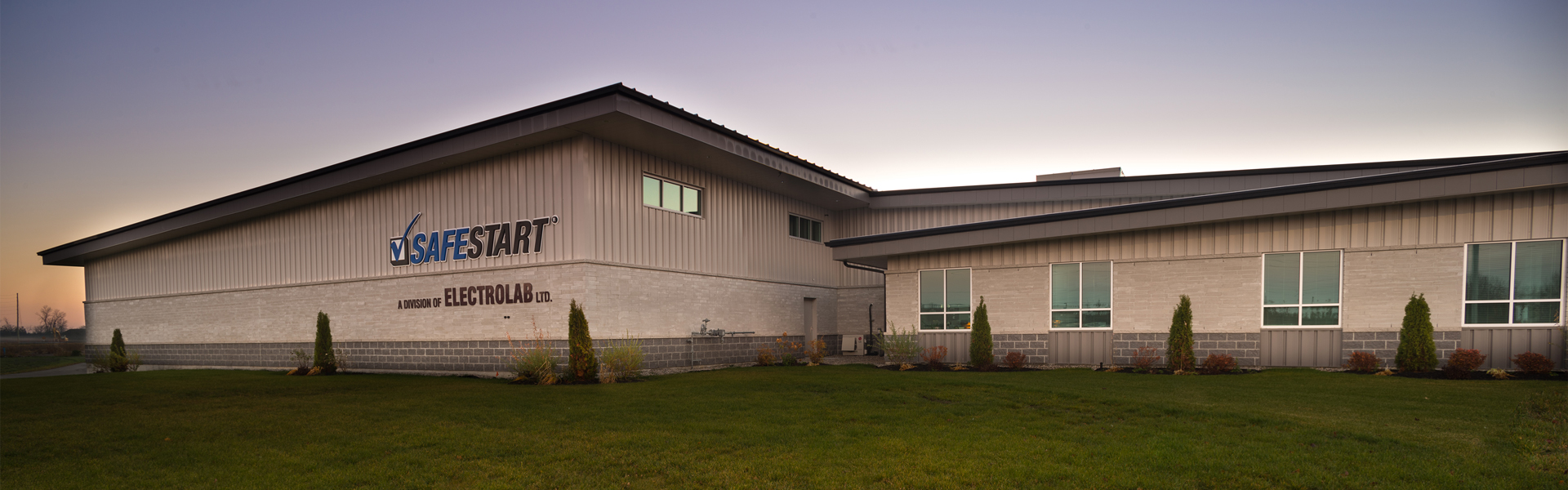 SafeStart facility exterior at dusk showing a long white metal building