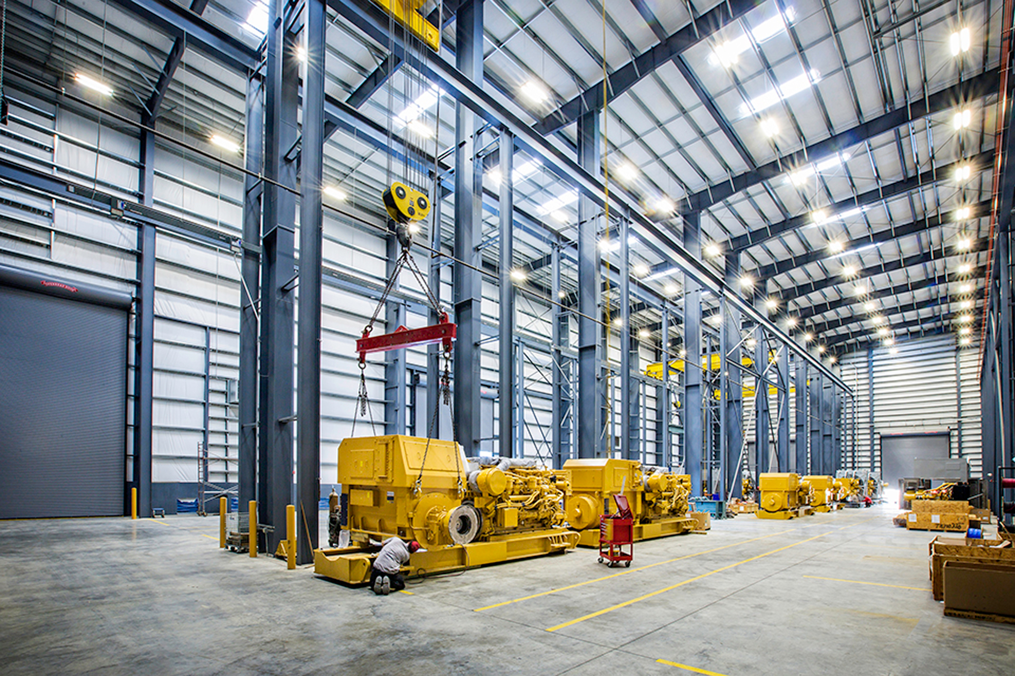 Louisiana Caterpillar interior with exposed steel columns, overhead cranes and machinery
