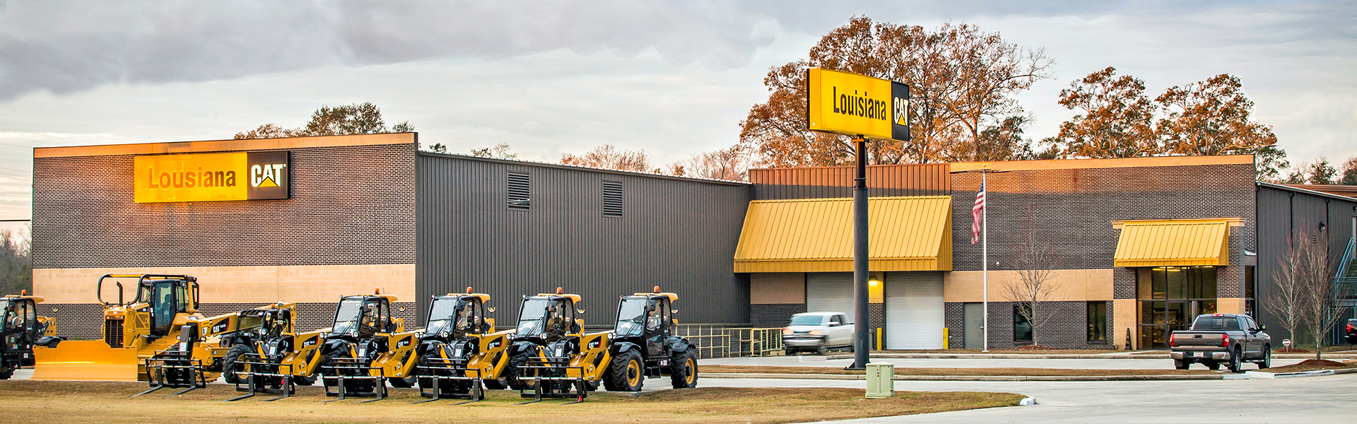 Louisiana Caterpillar dealership exterior with a metal building, storefront signage, and heavy machinery