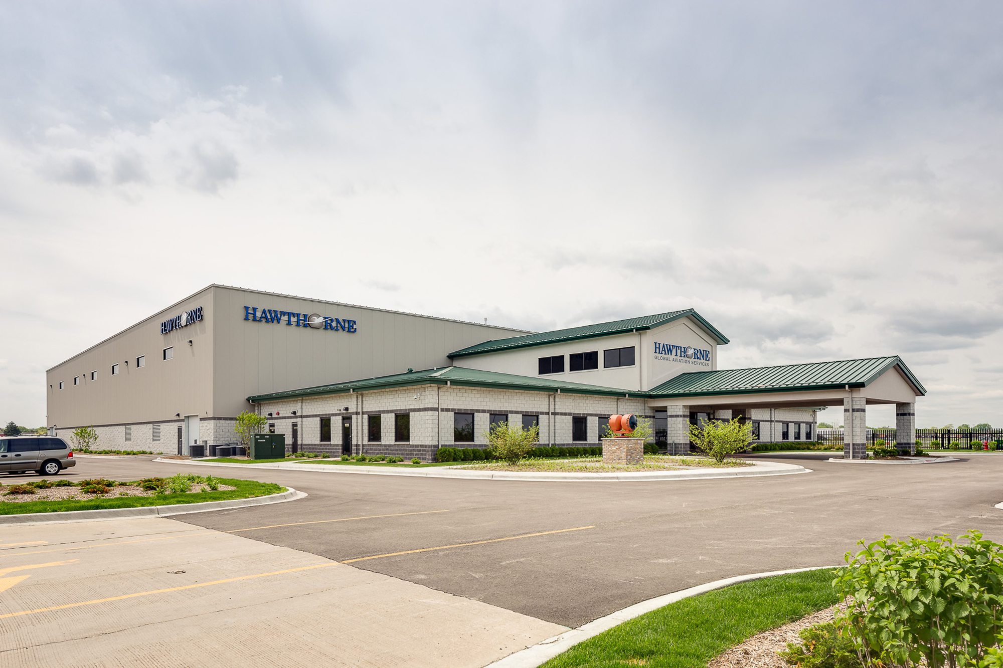 Hawthorne Global Aviation Services facility with metal roof and white metal wall panels