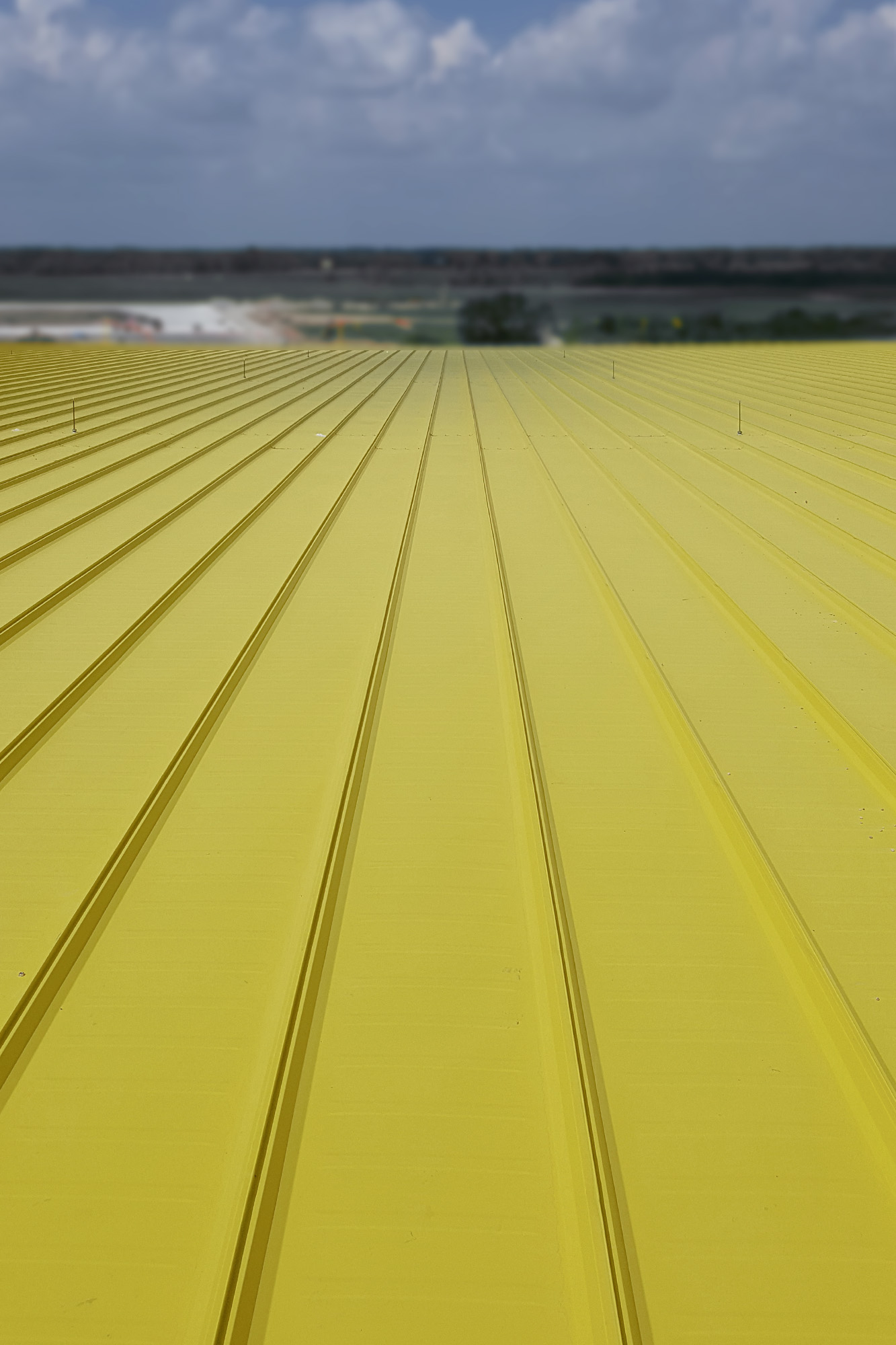 Spirit Airlines Maintenance Hangar Yellow brand color standing-seam metal roof panels