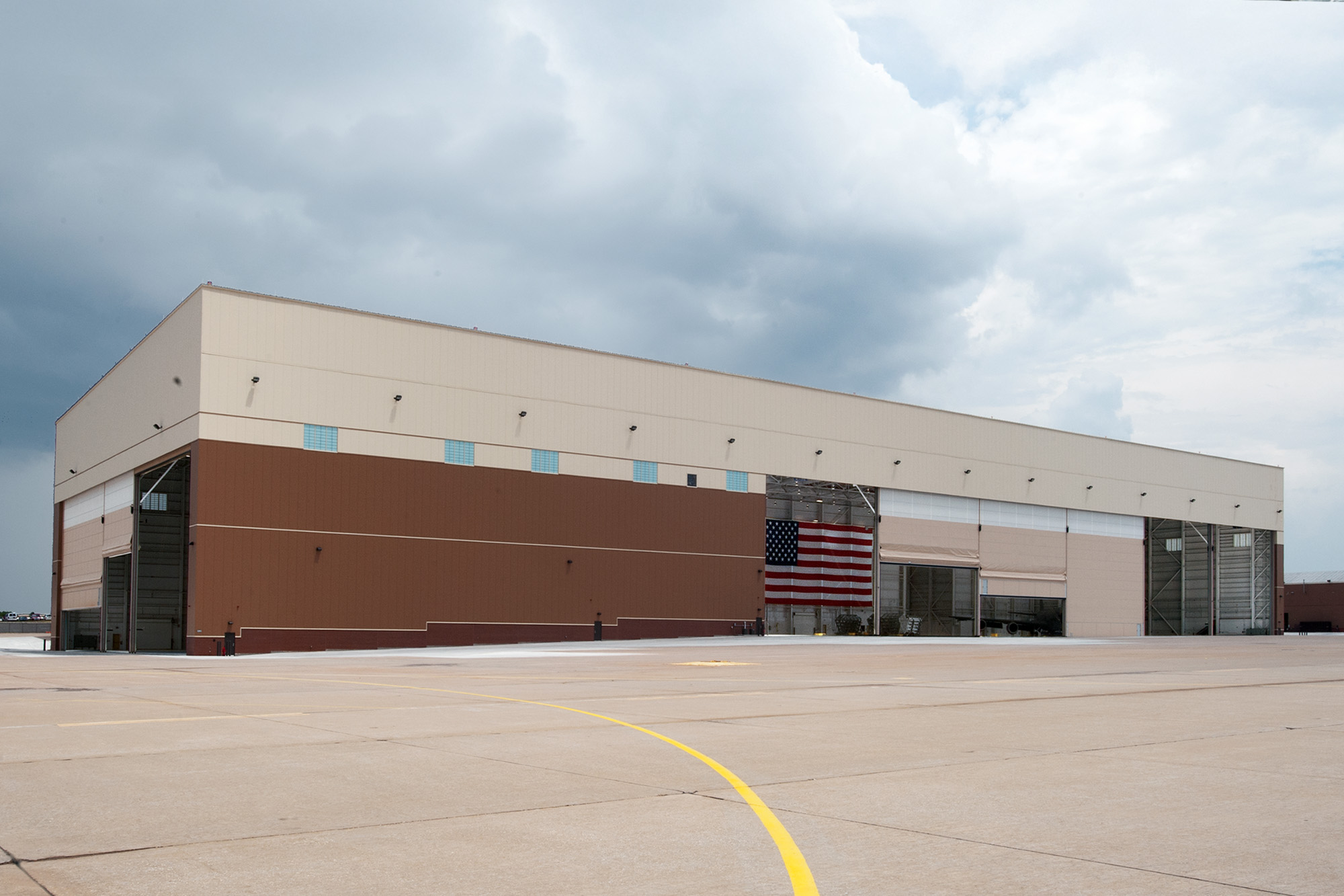 Large steel-framed aviation facility featuring expansive hangar doors and a durable exterior, demonstrating Butler’s engineered solutions for complex aviation operations.
