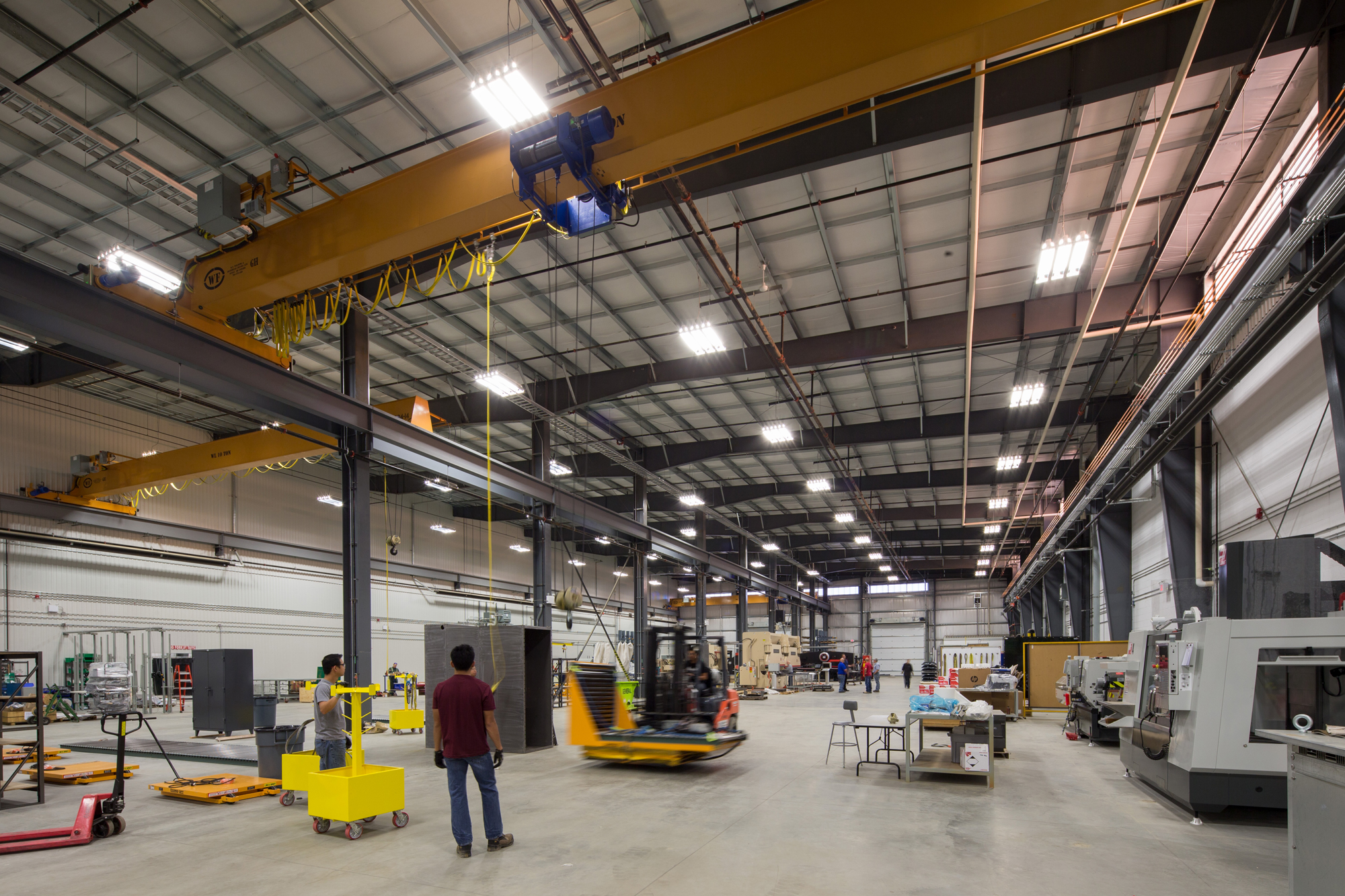 Powell Canada's large open bay manufacturing floor with exposed steel roof framing