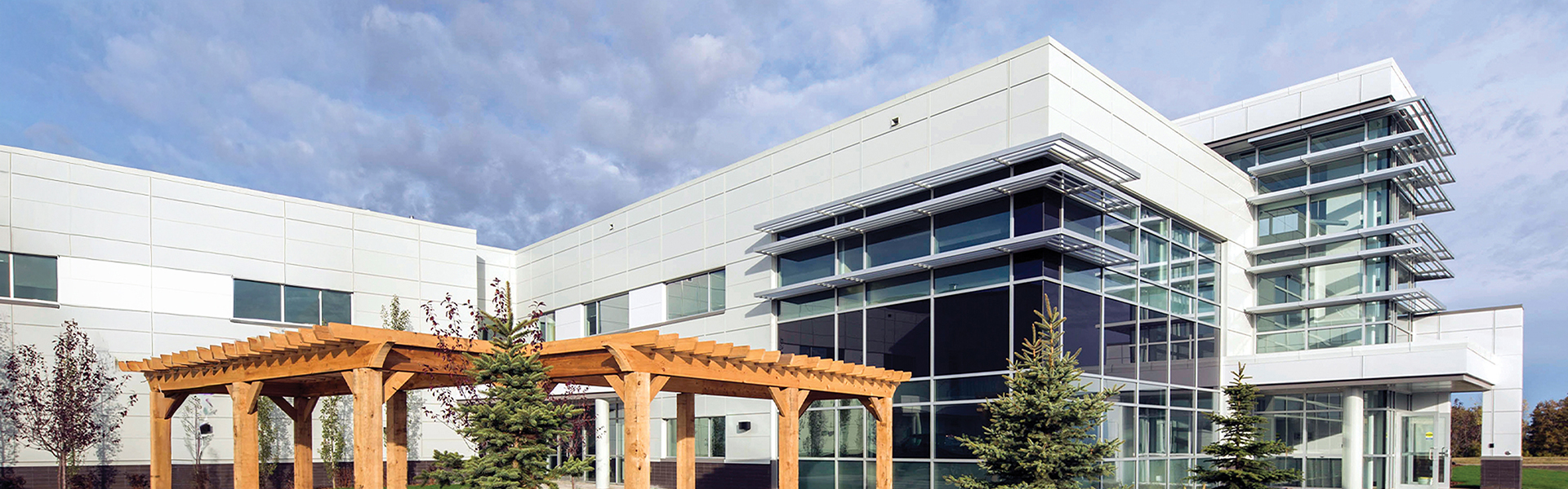 Powell Canada office building with glass curtain wall, white metal panels and exterior sunshades