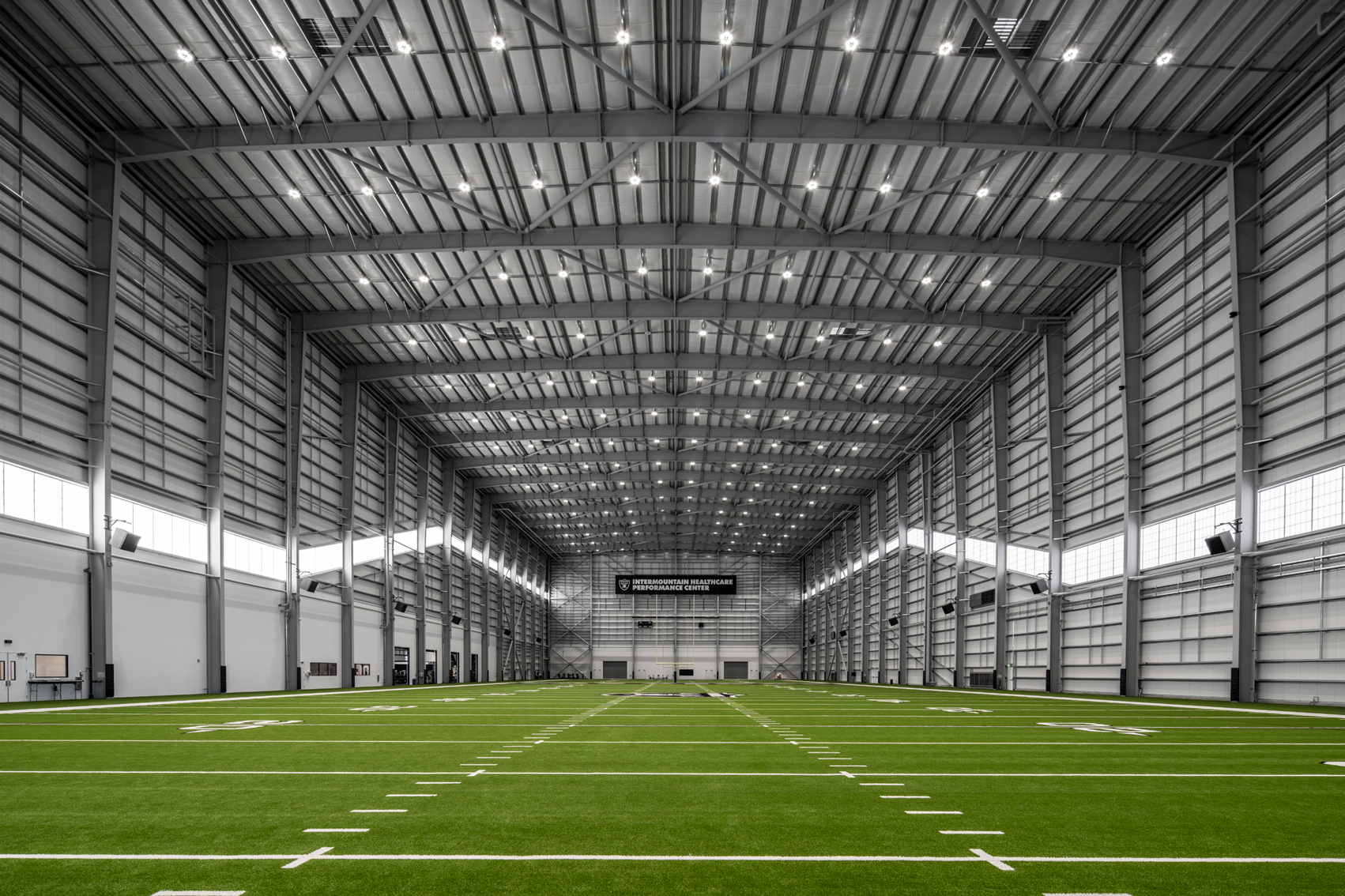 Large indoor sports training facility with clear-span steel framing, high-performance roof system, and integrated lighting—engineered to deliver durability, open space flexibility, and consistent performance for athletic use.