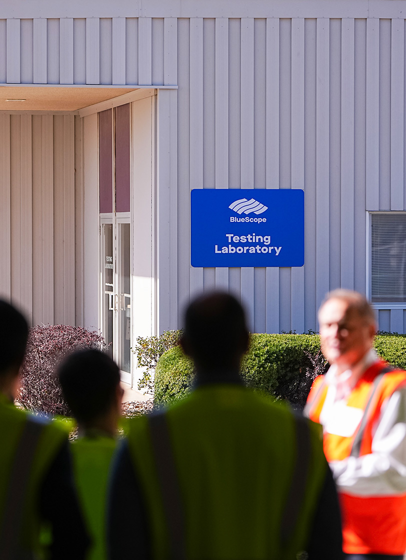 Butler testing facility exterior with workers in safety gear