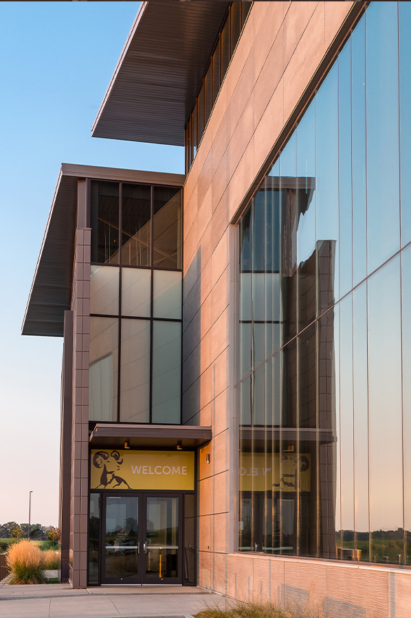 Contemporary commercial facility with large glass curtain wall and steel structure designed for complex building conditions.