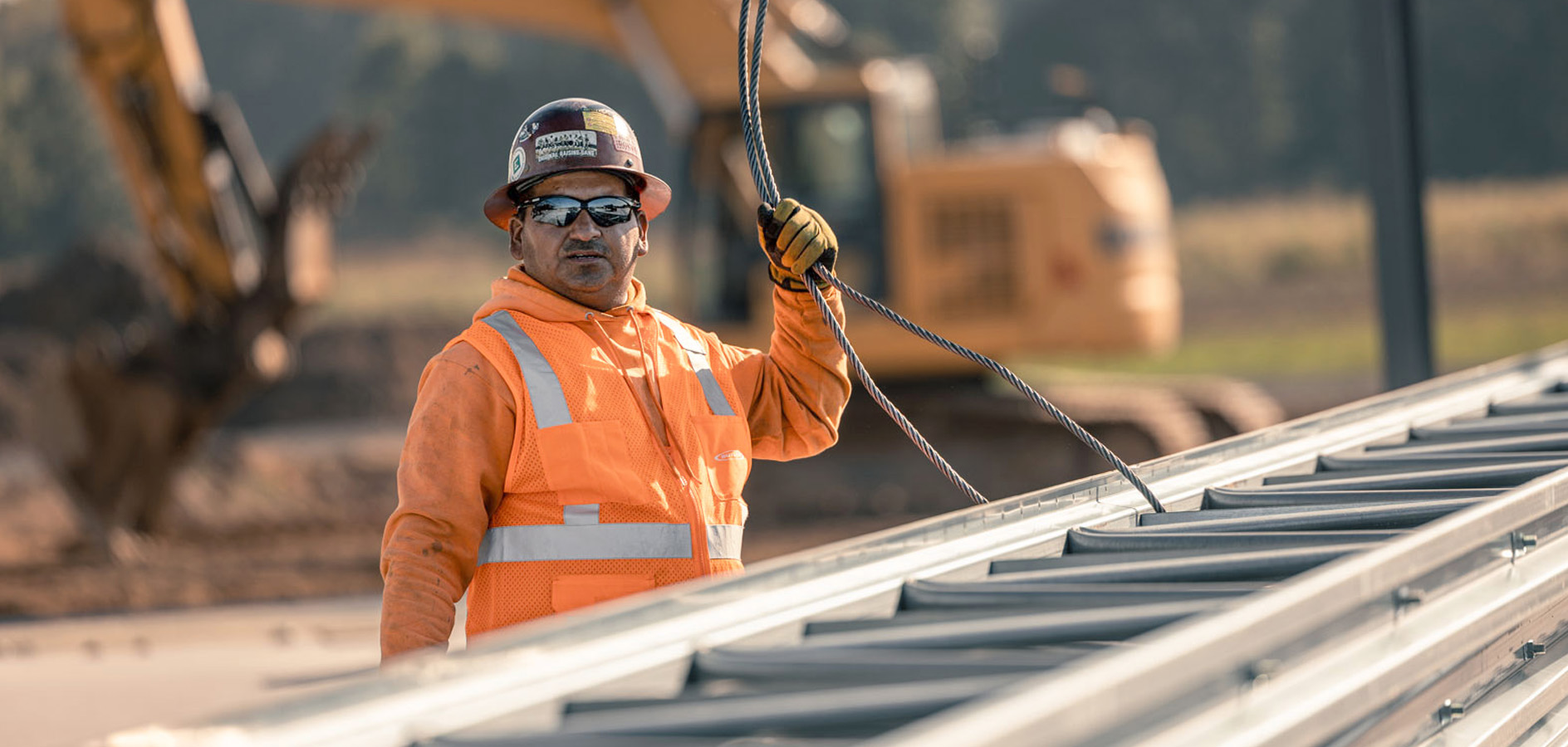 Butler builder securing steel beams for erection