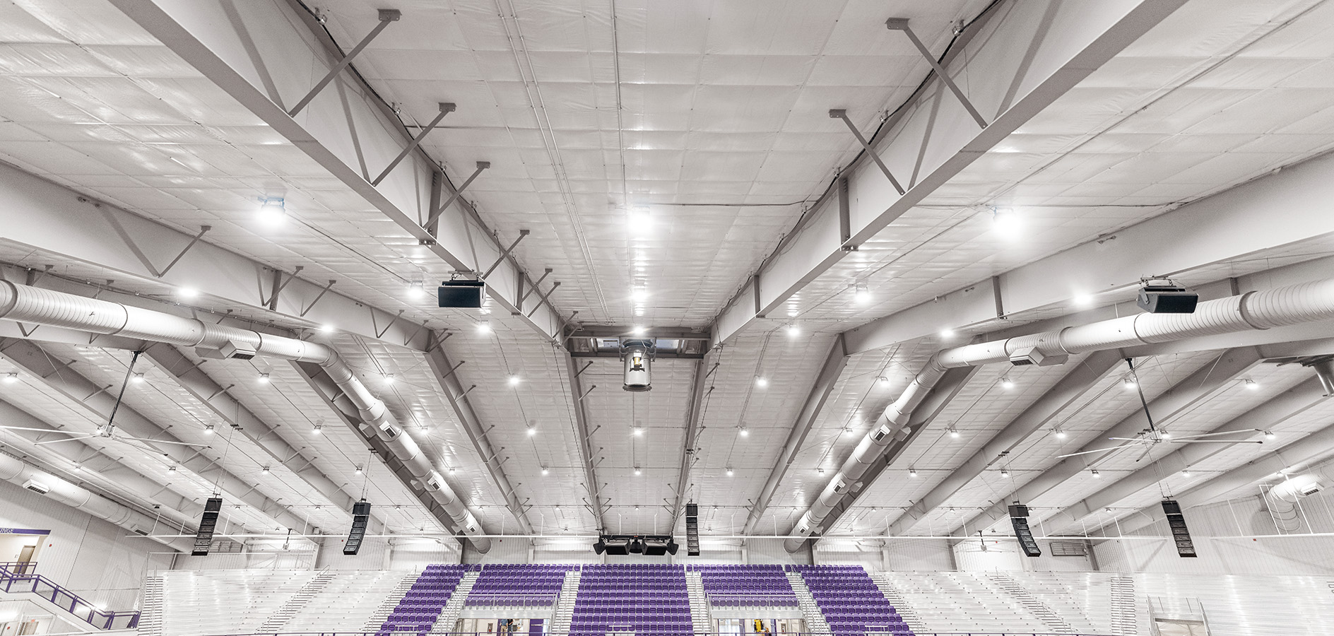 Indoor sports arena with exposed steel framing and ductwork